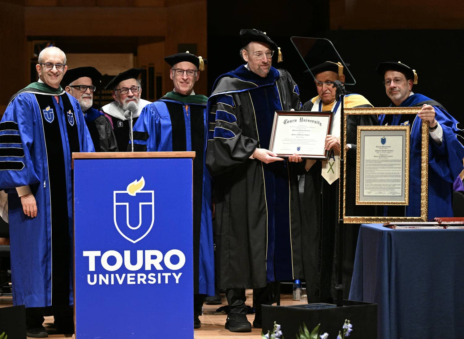 Members of Touro's senior leadership confer an honorary degree to Shlomo Yehuda Rechnitz at university&rsquo;s 52nd annual commencement exercises held on May 31 at Alice Tully Hall at Lincoln Center.